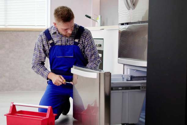 Electrician Technician Working To Repair Refrigerator Or Fridge Appliance